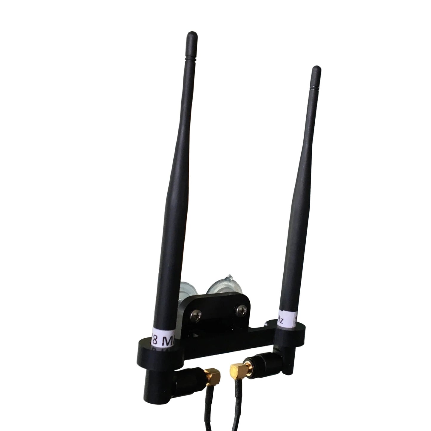 Two black whip antennas mounted inside an aircraft with a mounting bracket, alongside cables and suction cups.